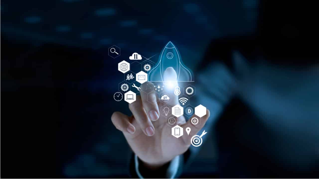 imagem de mãos tocando uma tela de touch transparente, com alguns ícones na tela
