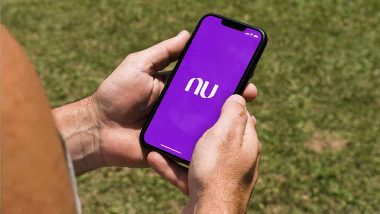 Pessoa segurando celular com o aplicativo do Nubank