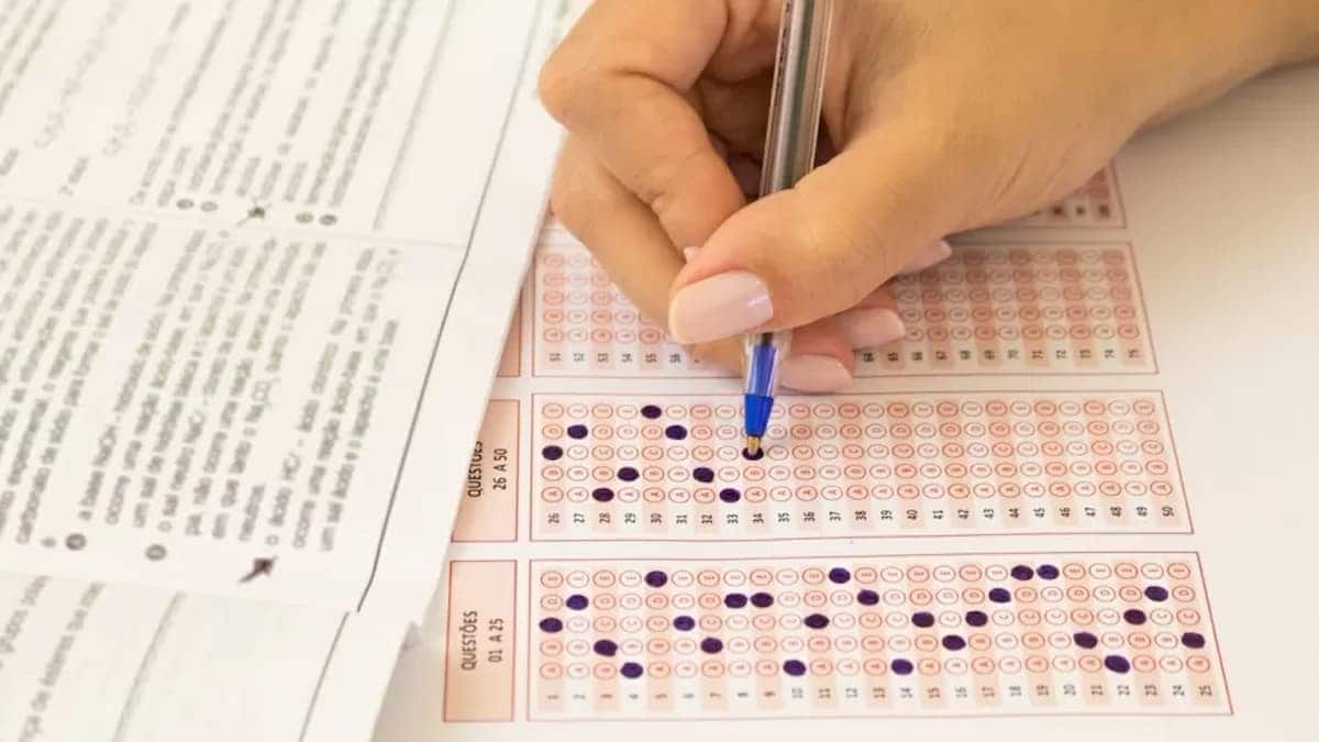 Pessoa marcando suas respostas no cartão-resposta de concurso que presta