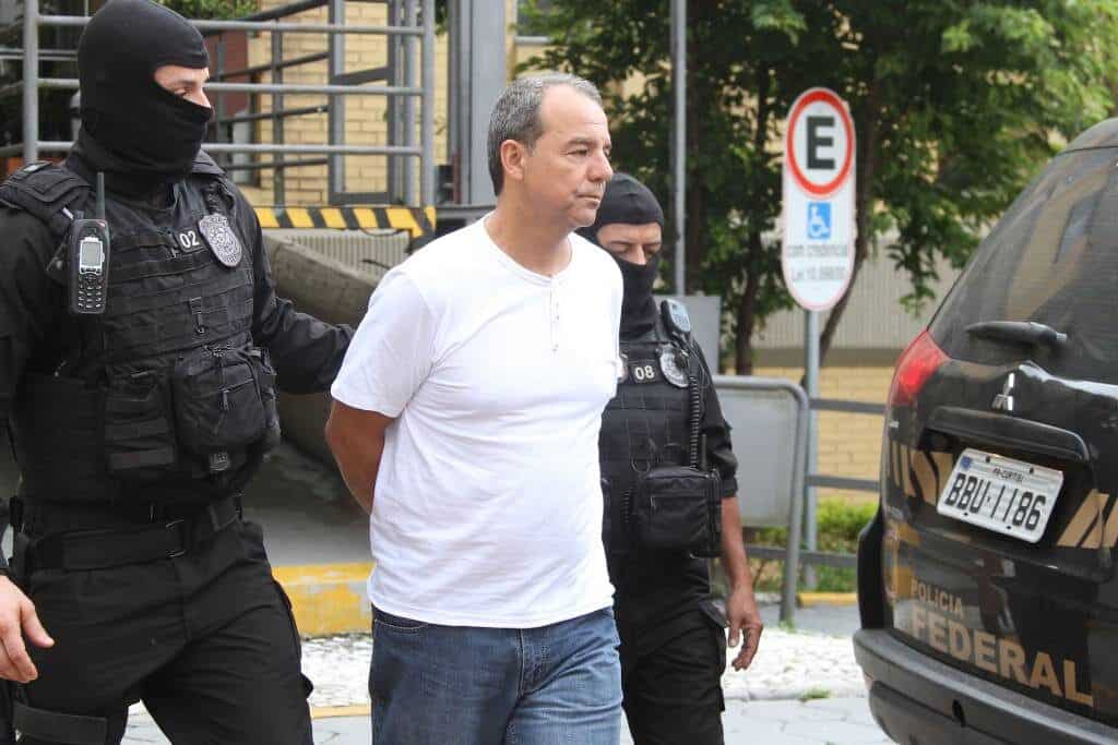 Ex-governador do Rio de Janeiro, Sérgio Cabral, algemado e sendo conduzido por policiais