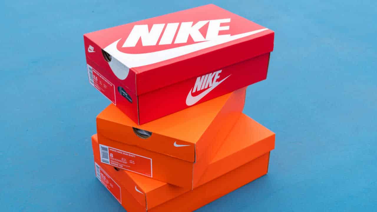 Caixa de produtos Nike, duas laranja e uma vermelha, empilhadas