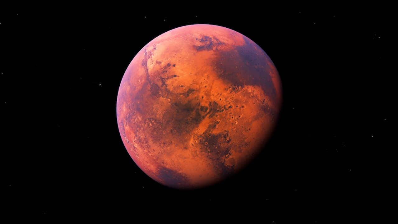 Imagem do planeta Marte em tons vermelhos com fundo escuro