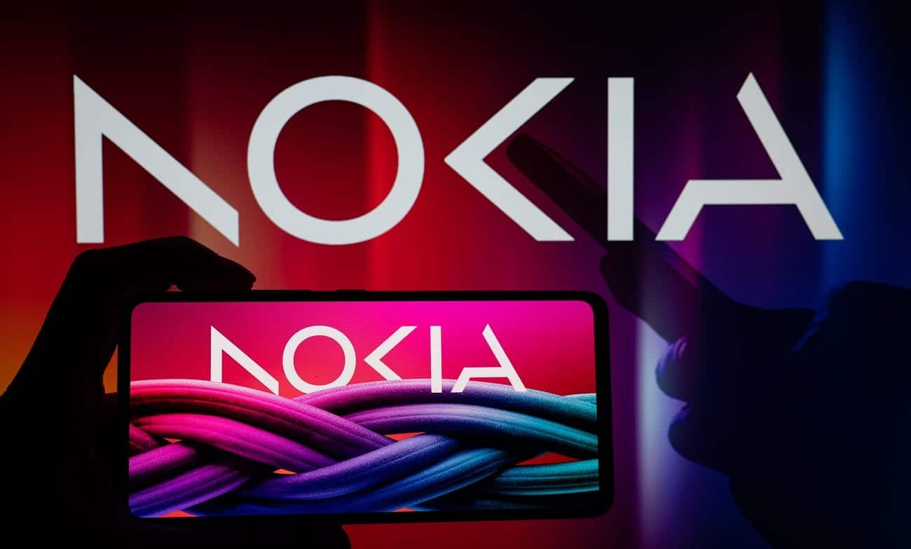 Celular com a nova logo da Nokia na tela. No fundo, na parte de cima, também há a logo da empresa