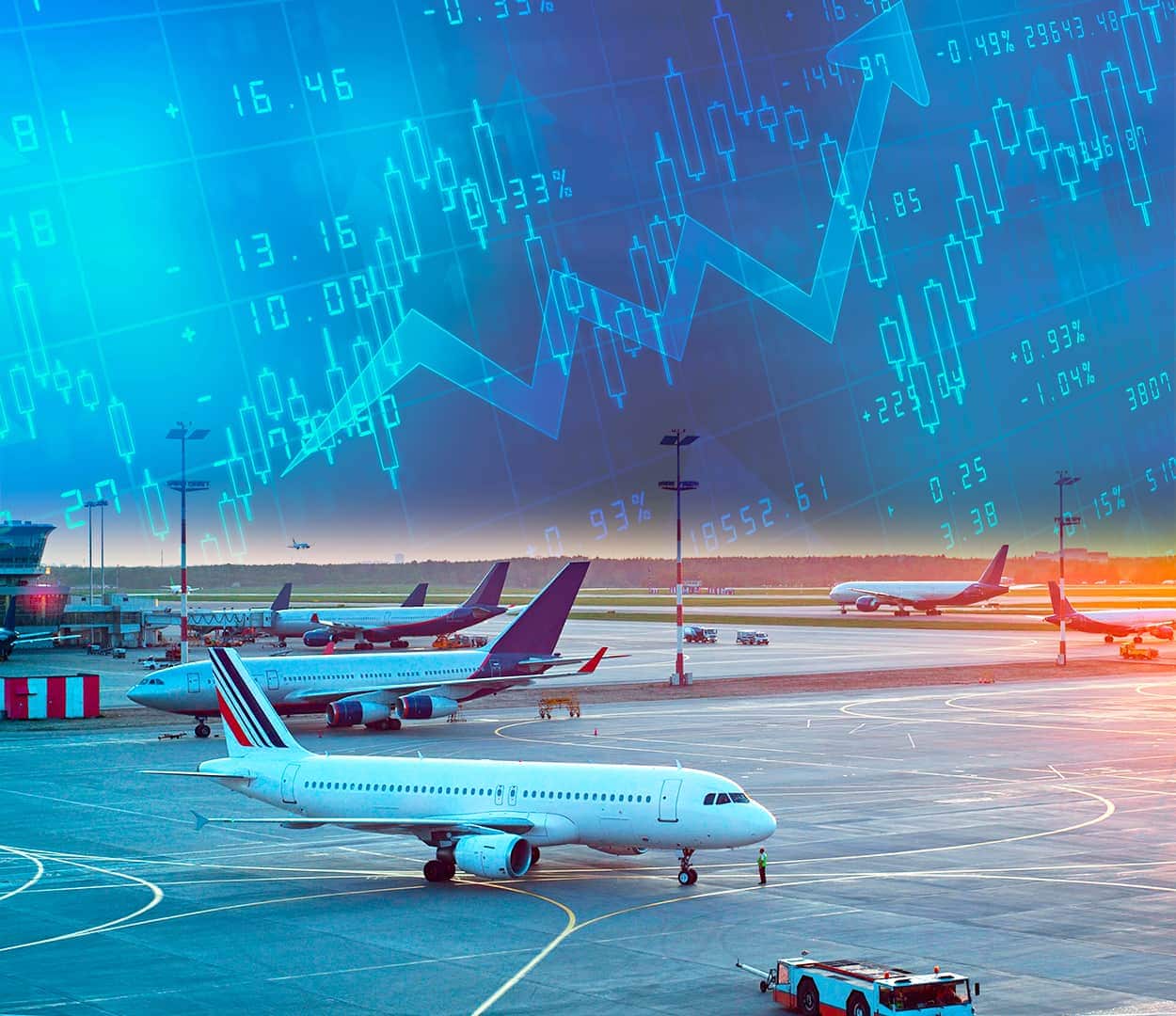 Aviões estacionados em aeroporto com arte gráfica de ações ao fundo