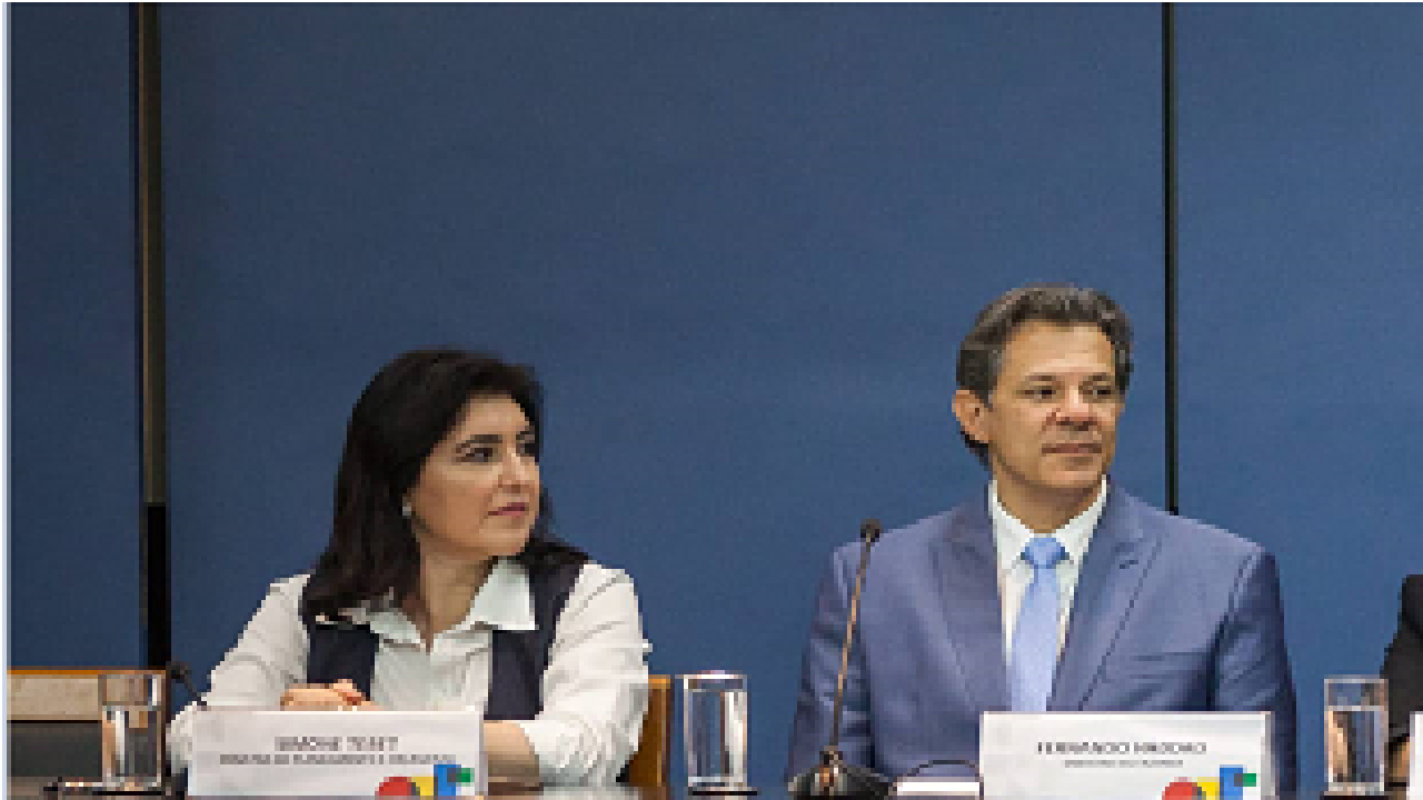 Simone Tebet e Haddad sentados olhando para o lado