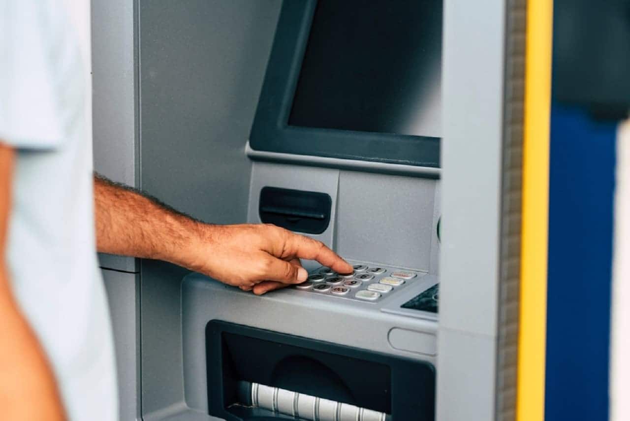 Imagem de uma pessoa utilizando um caixa eletrônico
