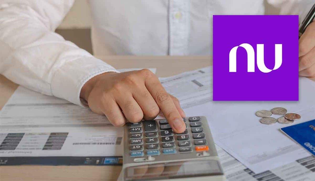Pessoa usando uma calculadora com a logo do banco Nubank sobreposta à foto.