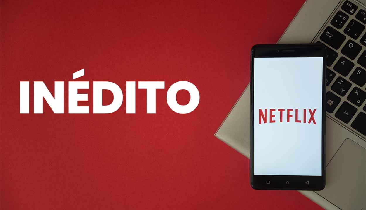 Imagem de um telofone aberto no aplicativo da Netflix em cima de um computador com um fundo vermelho