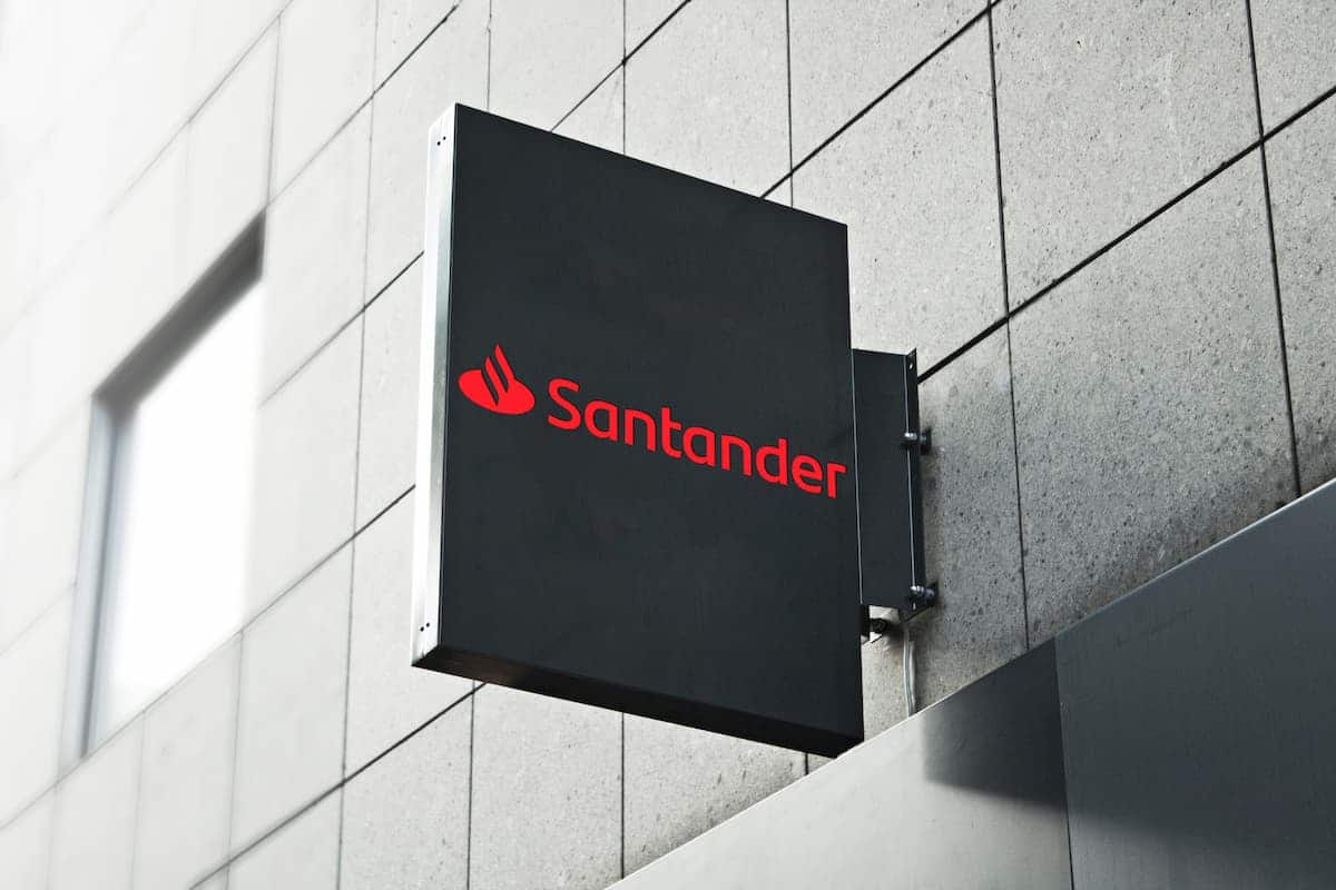 Logotipo do Santander em placa de fachada de prédio.