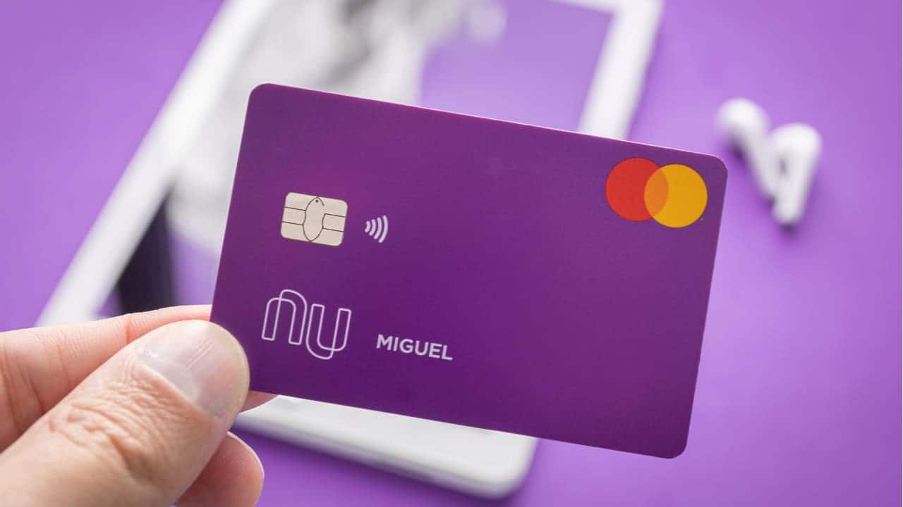 Pessoa segura cartão de crédito do Nubank