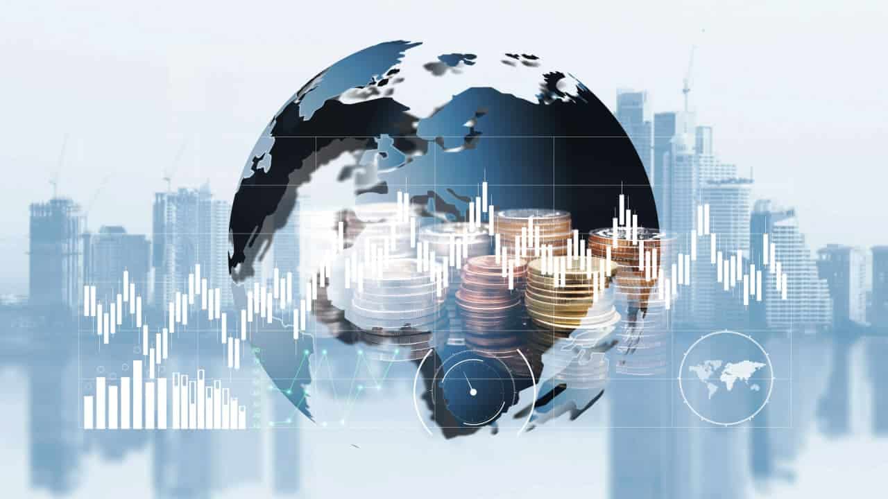 imagem de globo mundial e diversas moedas e gráficos financeiros