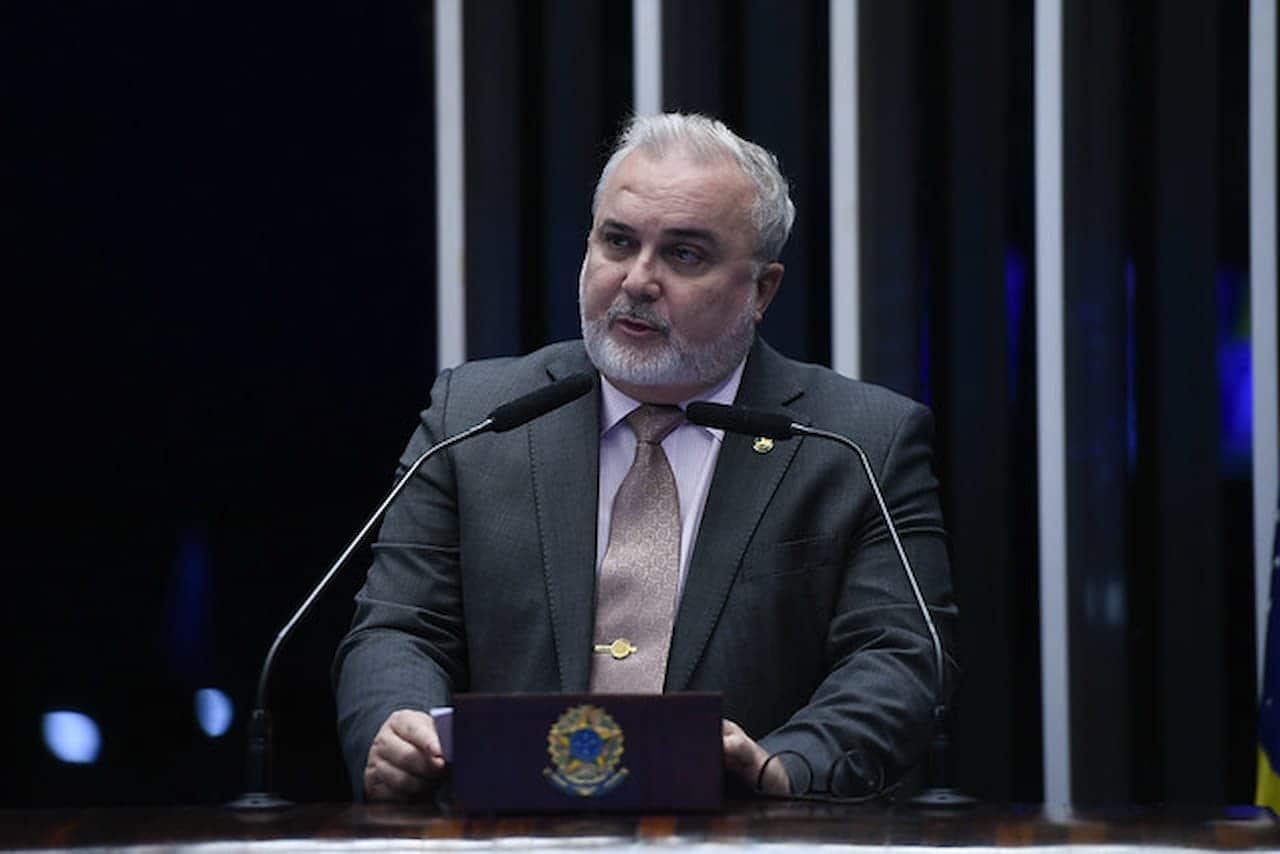 Jean Paul Prates em discurso com dois microfones à sua frente