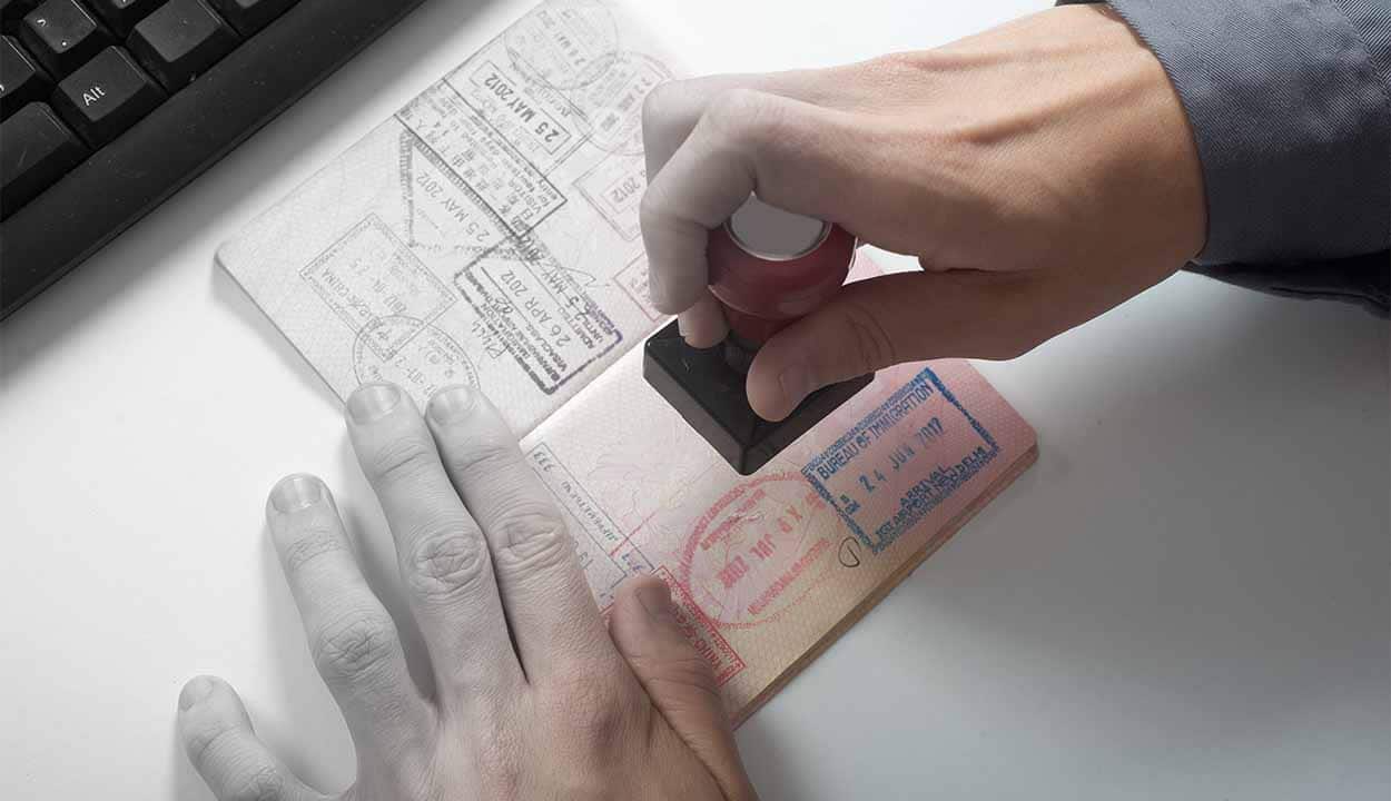 homem carimbando passaporte com visto para viagem internacional