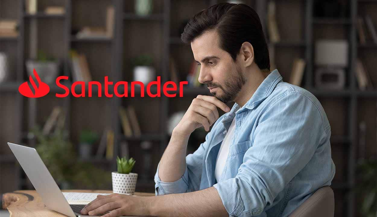 Homem utilizando laptop. Ao seu lado esquerdo, logo do Santander
