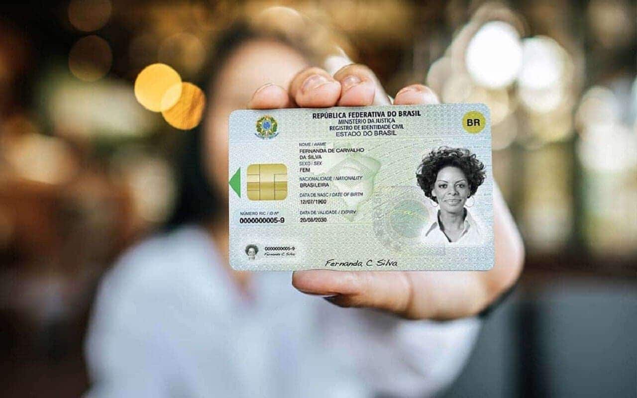 Pessoa segurando o RG (Registro Geral) que acabou de ser emitido. carteira de identidade
