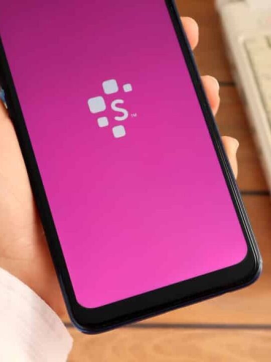 Mão segurando celular com aplicativo da Serasa