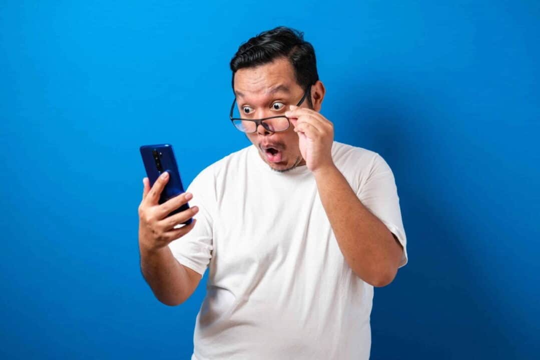 Homem olhando surpresa para o celular