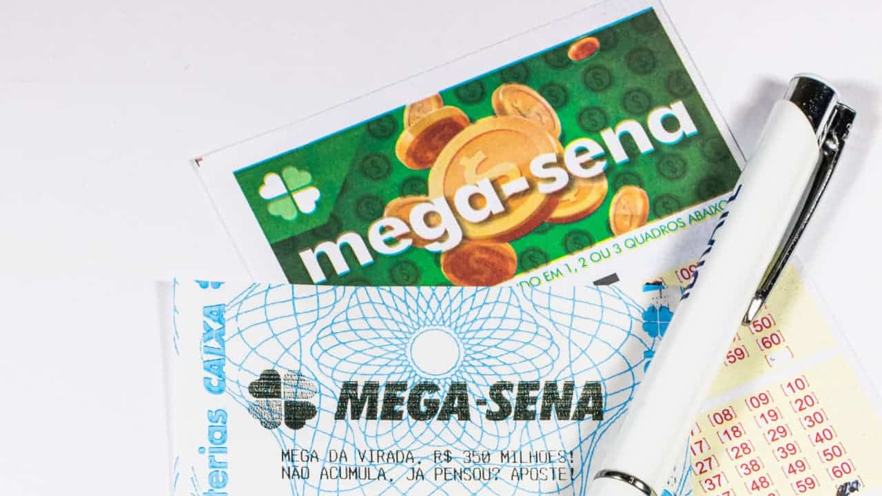 Volante da Mega-Sena, comprovante e caneta.