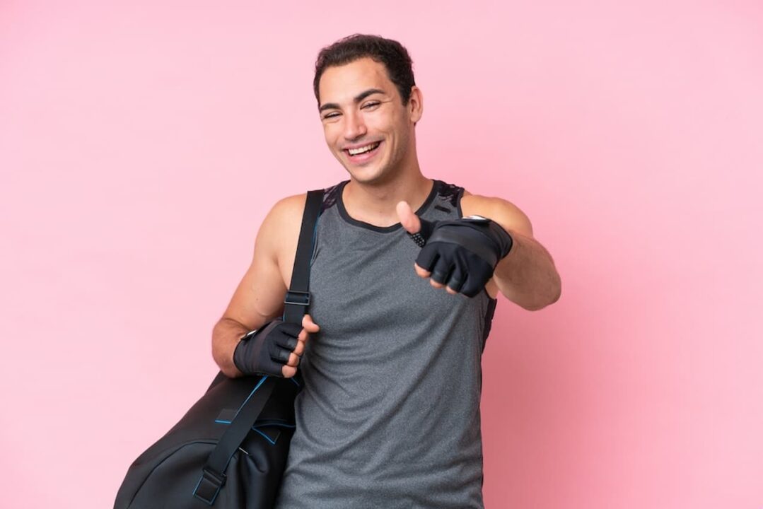 Jovem atleta sorrindo e fazendo sinal de legal com o polegar