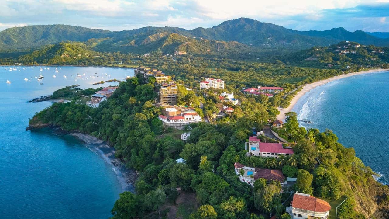 Paisagem com praia e montanhas com matas localizada na Costa Rica